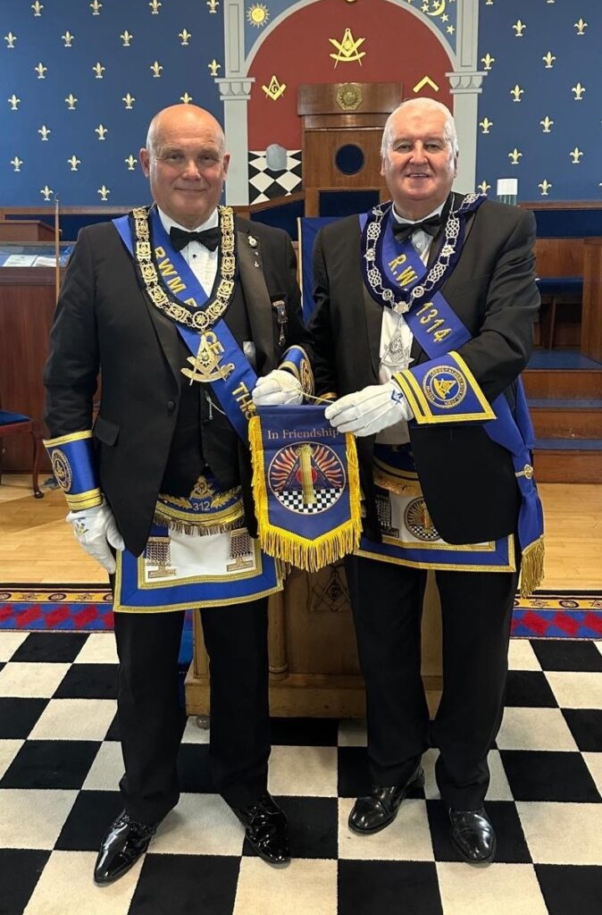 RWM Bro. Richard A. Kerry accepts friendship pennant from RWM Bro. Henry Dunbar