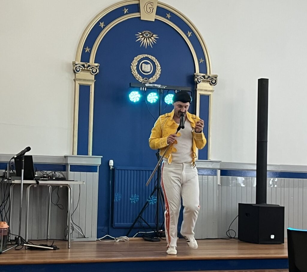 Neil Angus as Freddie Mercury